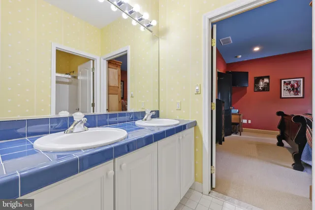 a bathroom with a sink vanity mirror and toilet