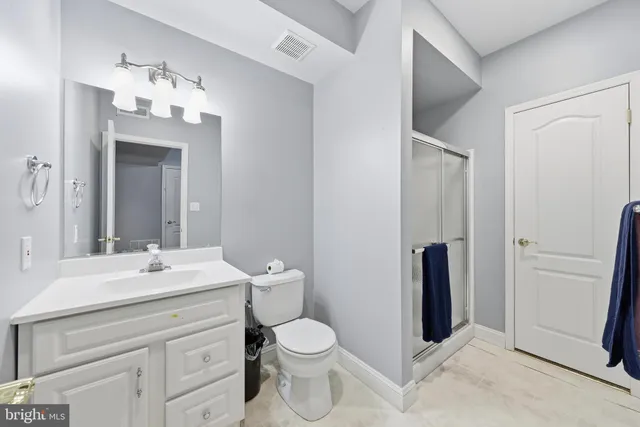 a view of white house with yard and trees in the background