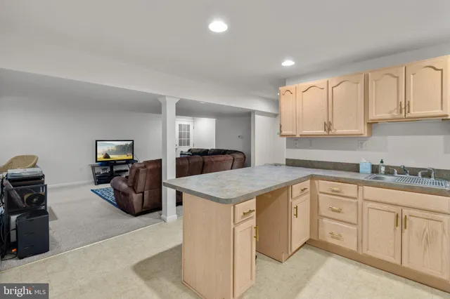 a kitchen with cabinets appliances a sink and a counter top space