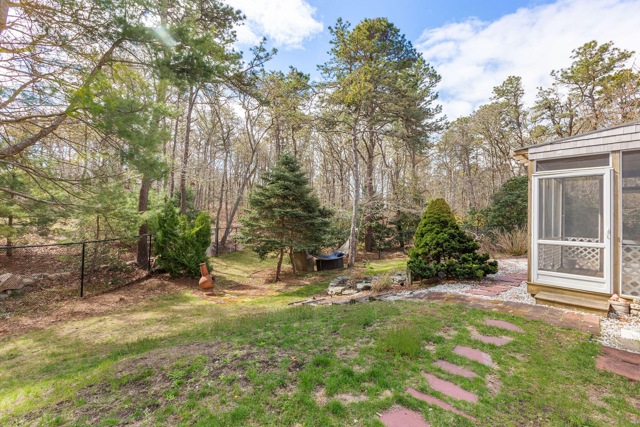 1197 Orleans-Harwich Road Harwich, MA 02645 - Photo 62 of 66 a view of a backyard with plants and large trees