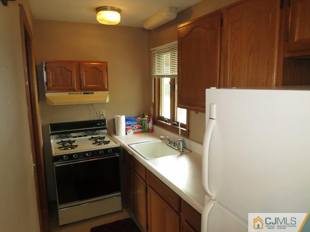 126 New Market Road Dunellen, NJ 08812 - Photo 22 of 24 a kitchen with a sink stove and refrigerator