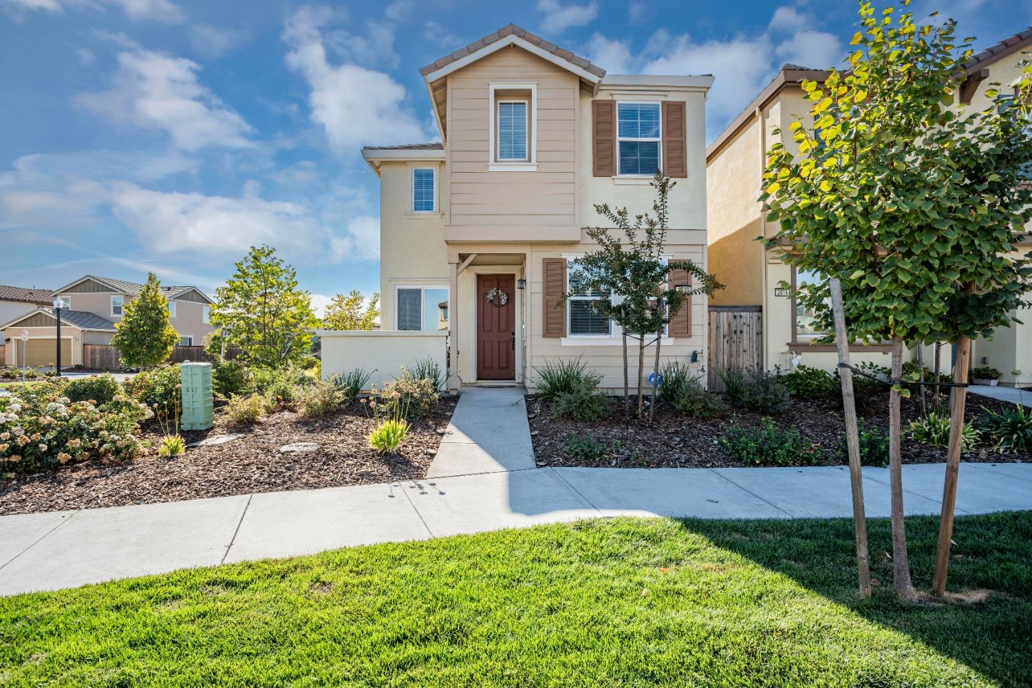 2510 Natomas Crossing Drive Sacramento, CA 95834 - Photo 1 of 34 a front view of a house with a yard and potted plants