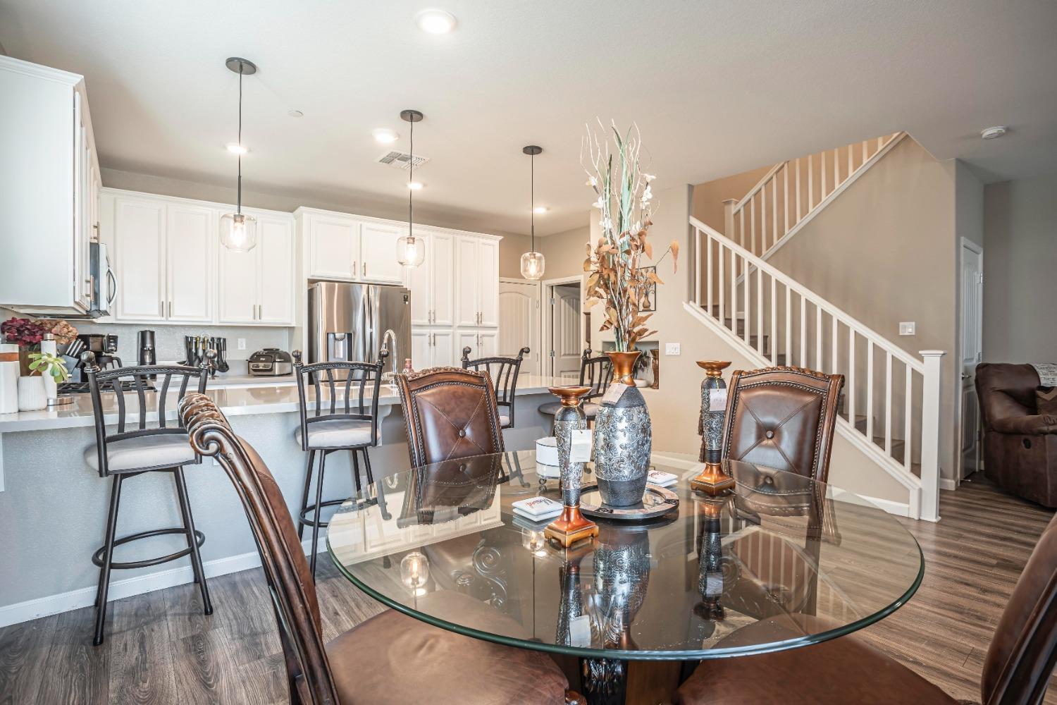 2510 Natomas Crossing Drive Sacramento, CA 95834 - Photo 12 of 34 a view of a dining room with furniture a kitchen and chandelier