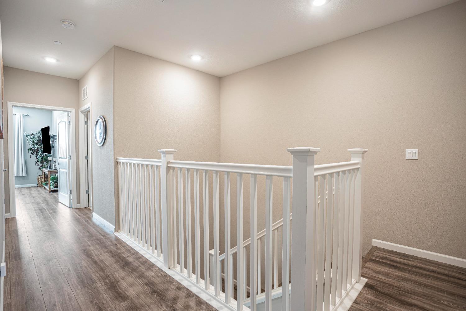 2510 Natomas Crossing Drive Sacramento, CA 95834 - Photo 14 of 34 a view of a hallway with wooden floor
