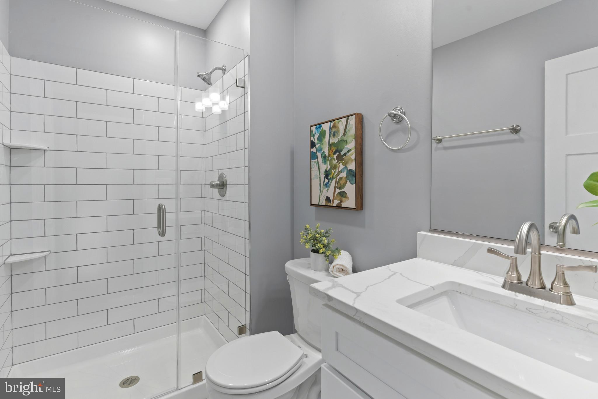 5728 Clover Road Baltimore, MD 21215 - Photo 21 of 40 a bathroom with a sink a toilet and shower