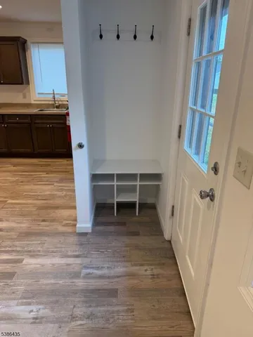 a view of a kitchen with cabinets and wooden floor