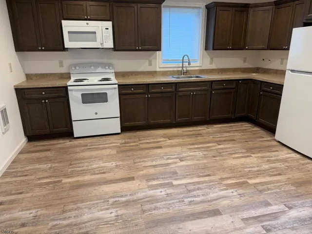 a kitchen with stainless steel appliances granite countertop a stove and a sink
