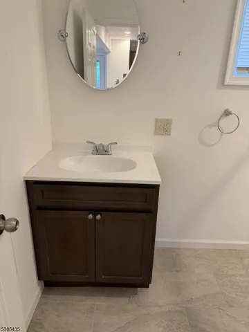 a bathroom with a sink vanity and a mirror
