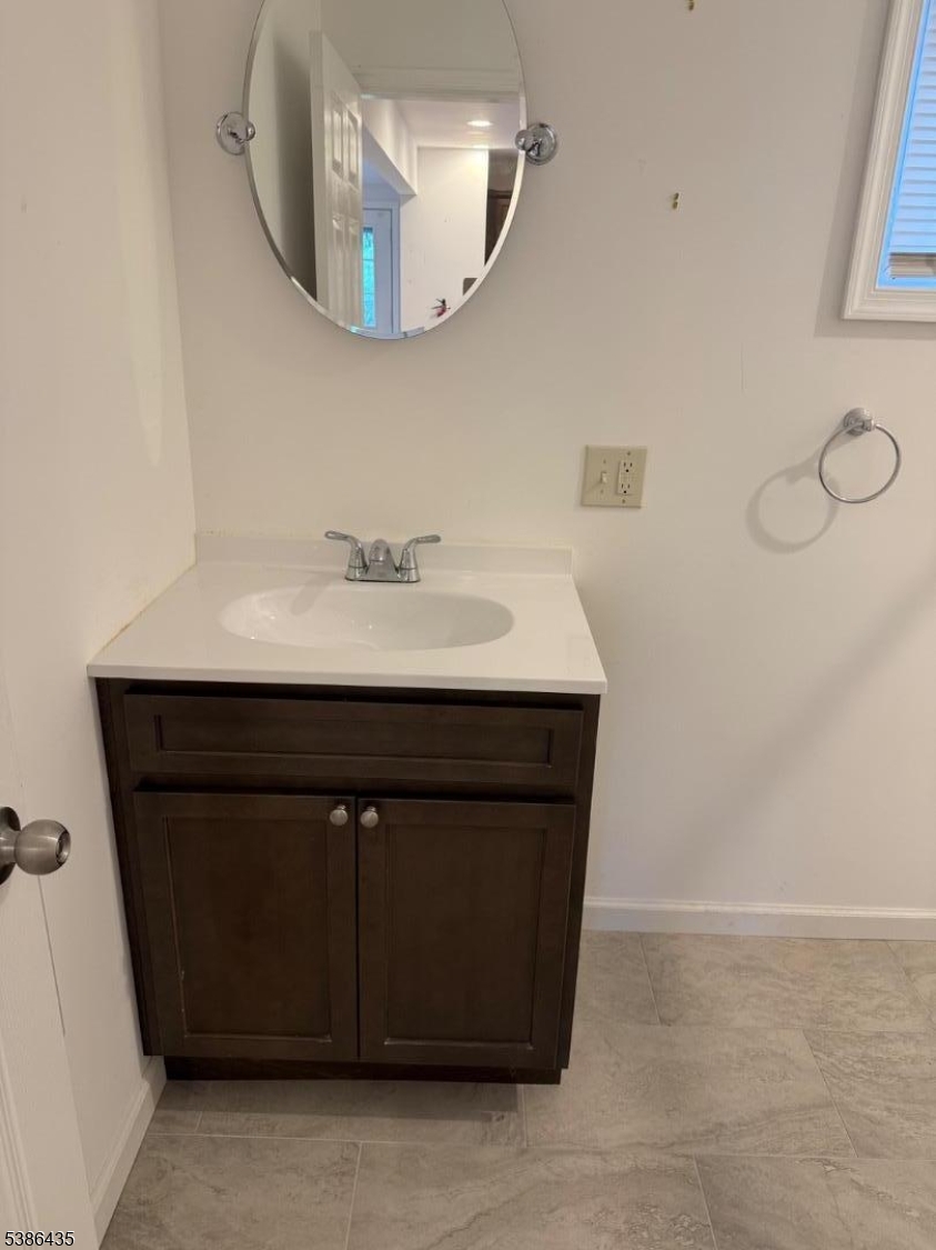 35 Grove Street, Unit B Wanaque, NJ 07465 - Photo 5 of 10 a bathroom with a sink vanity and a mirror