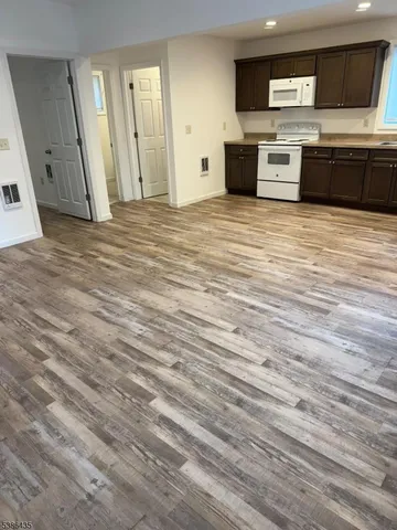 a view of a kitchen with a sink and a stove top oven