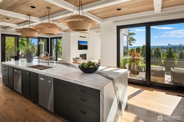 a kitchen with stainless steel appliances granite countertop a stove and a wooden floors