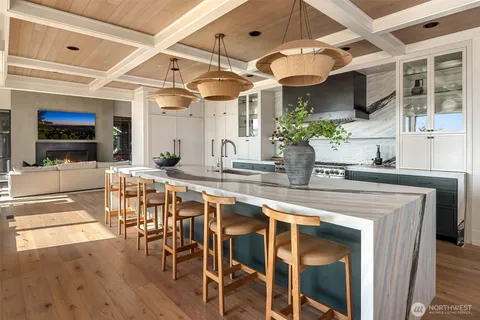 a kitchen with a table and a chandelier