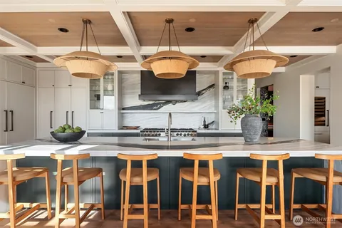 a kitchen with stainless steel appliances granite countertop a sink a stove and a wooden floors