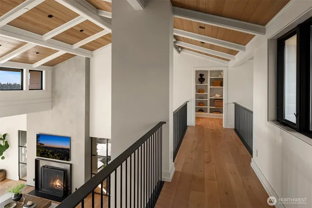 a bedroom with a bed couch and a large window