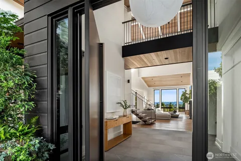 a view of entryway and hall with wooden floor