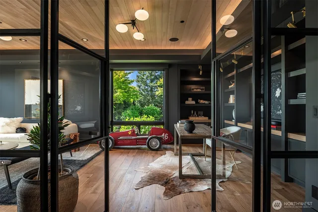 a living room with furniture and floor to ceiling windows