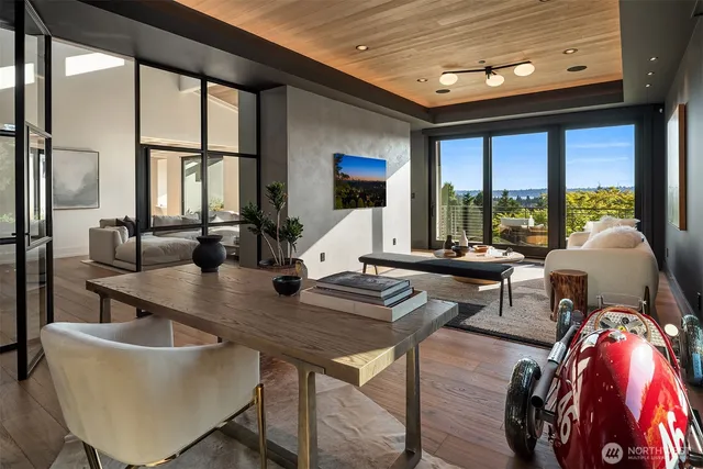 a living room with furniture flowerpot and wooden floor