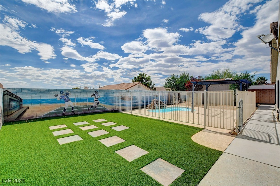 1118 Olmo Way Boulder City, NV 89005 - Photo 28 of 45 View of yard featuring a patio area and a community pool