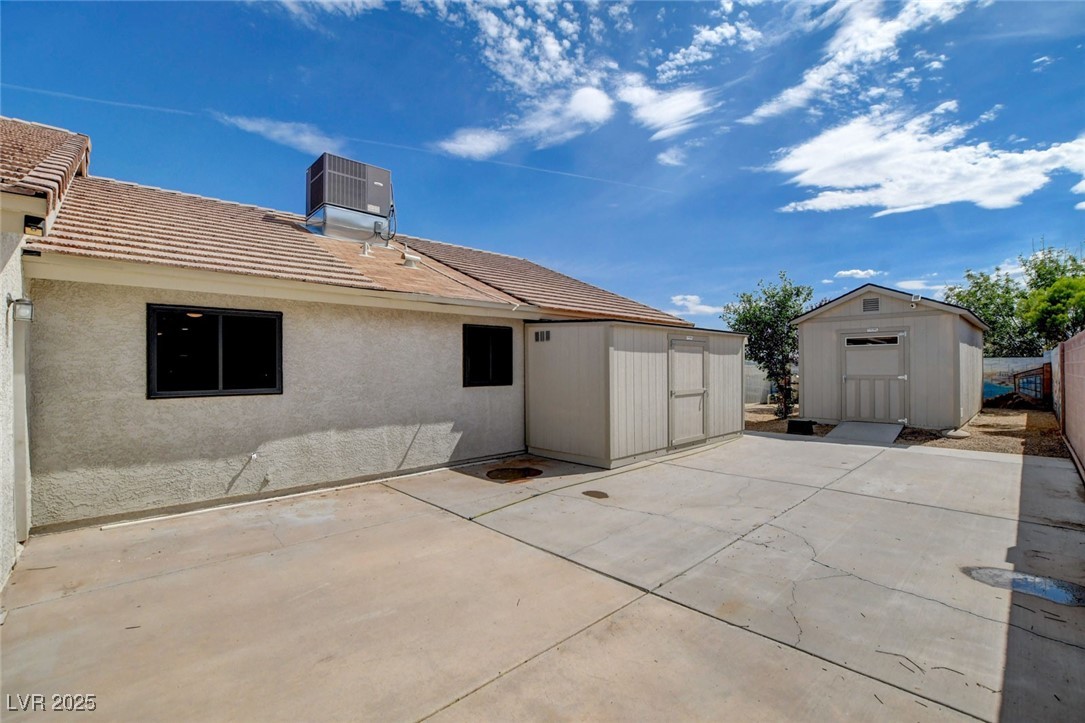 1118 Olmo Way Boulder City, NV 89005 - Photo 33 of 45 Back of property featuring a shed, stucco siding, and a tile roof