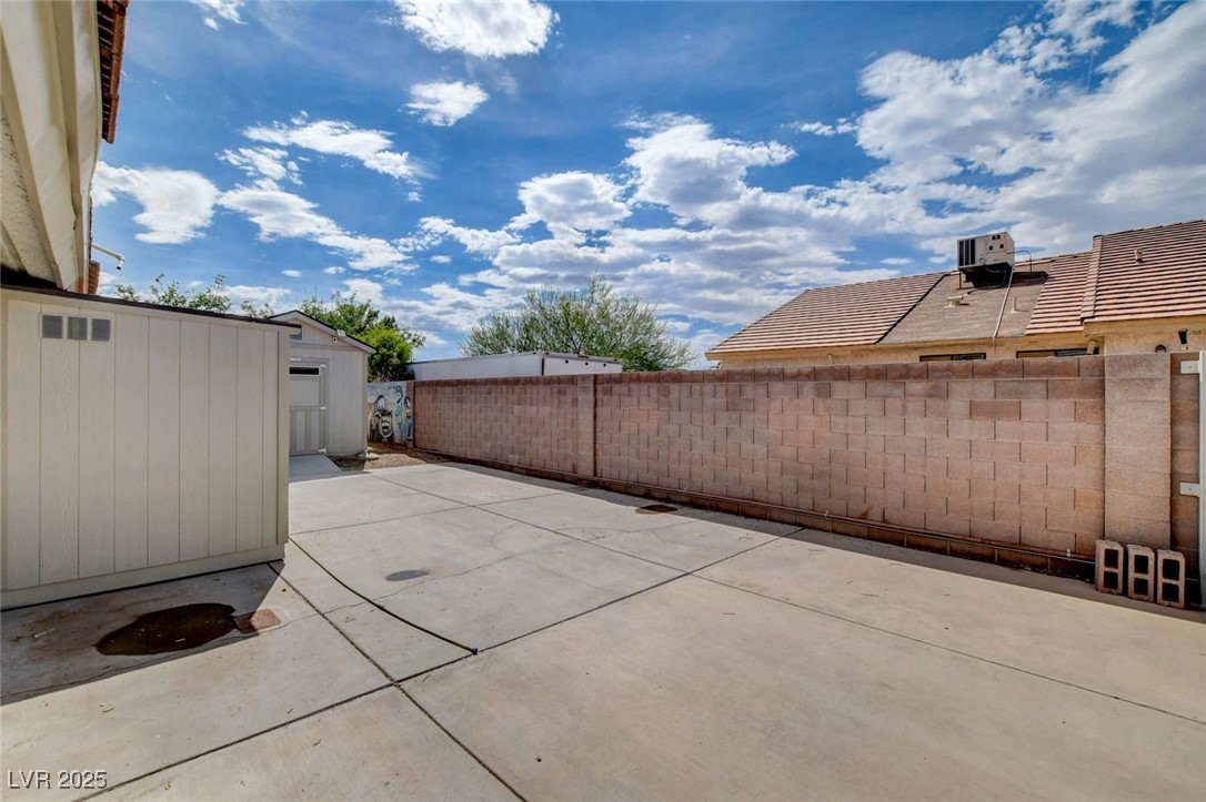 1118 Olmo Way Boulder City, NV 89005 - Photo 34 of 45 Fenced backyard featuring a patio area and a storage shed