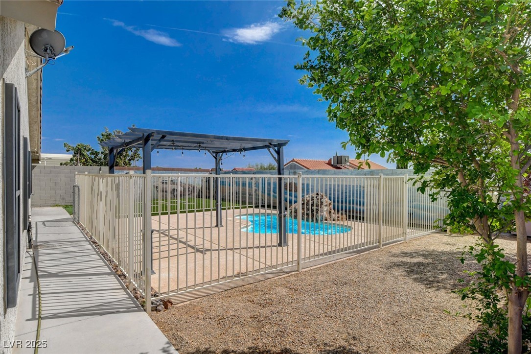 1118 Olmo Way Boulder City, NV 89005 - Photo 36 of 45 View of swimming pool featuring a patio, a fenced backyard, and a pergola