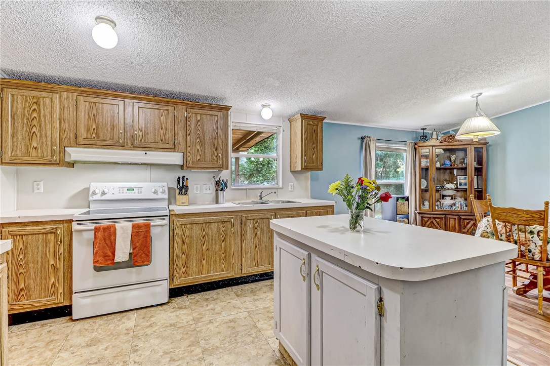 86064 Jones Road Yulee, FL 32097 - Photo 11 of 25 a kitchen with stainless steel appliances granite countertop a sink stove and cabinets