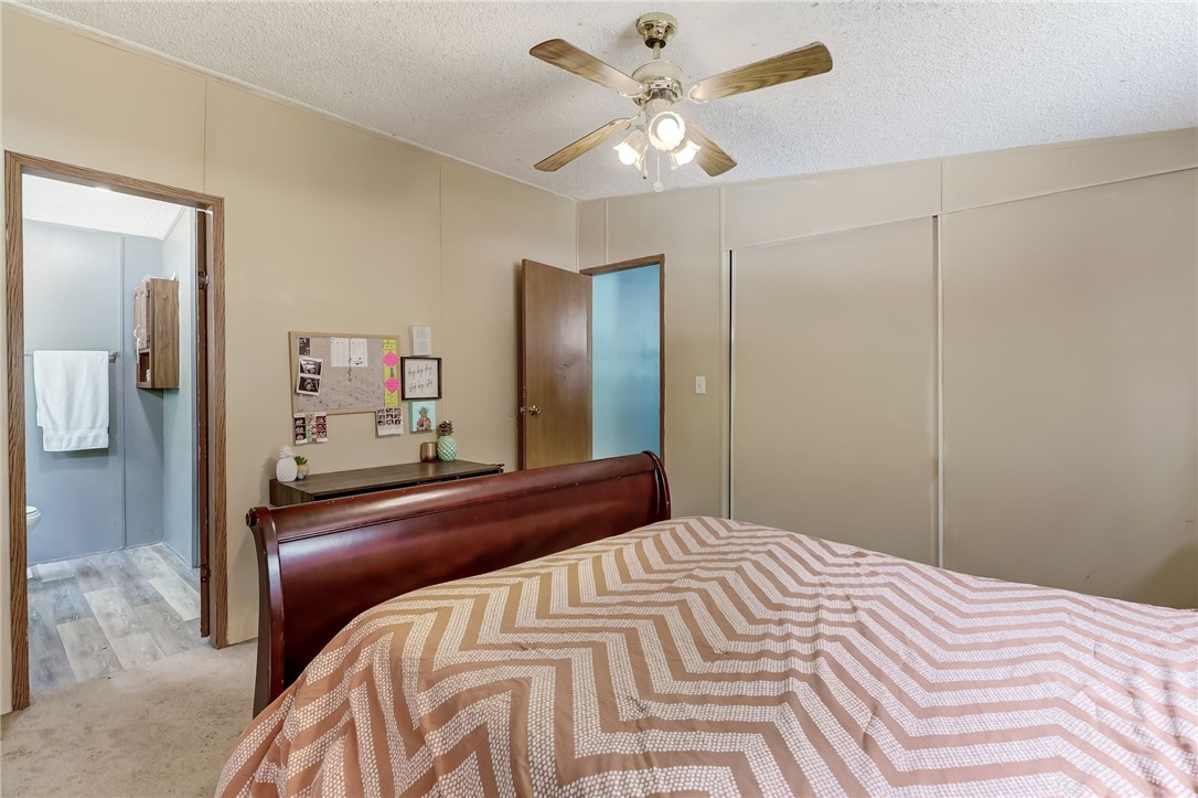 86064 Jones Road Yulee, FL 32097 - Photo 14 of 25 a bedroom with a large bed and a chandelier