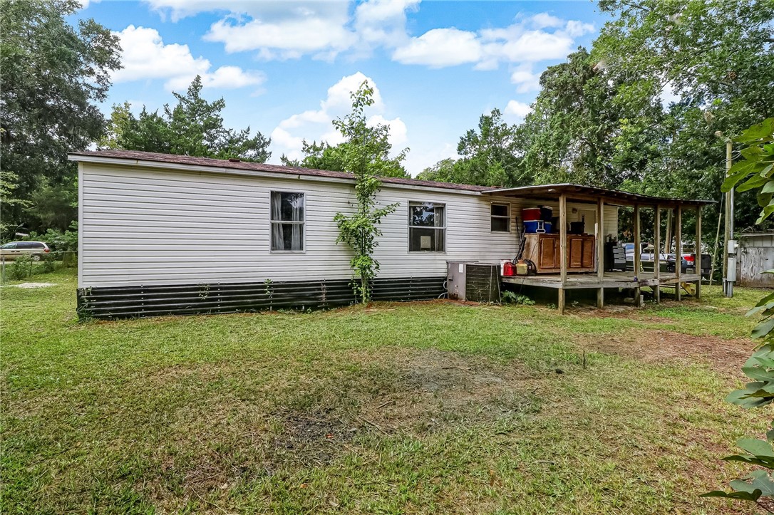 86064 Jones Road Yulee, FL 32097 - Photo 22 of 25 a view of a house with backyard and chairs