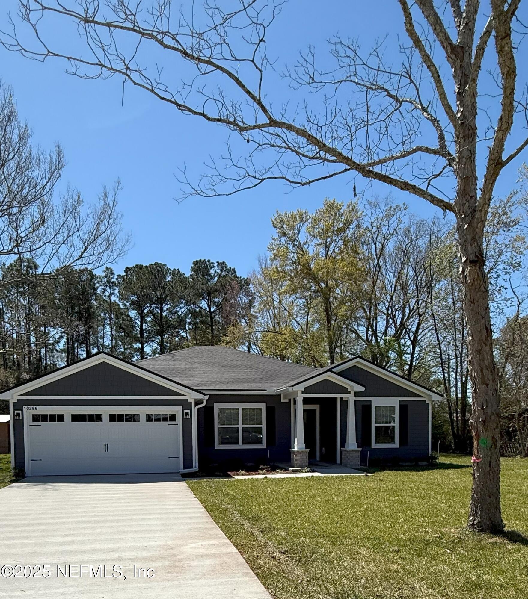 10286 Cisco Drive Jacksonville, FL 32219 - Photo 2 of 45 a front view of a house with a garden