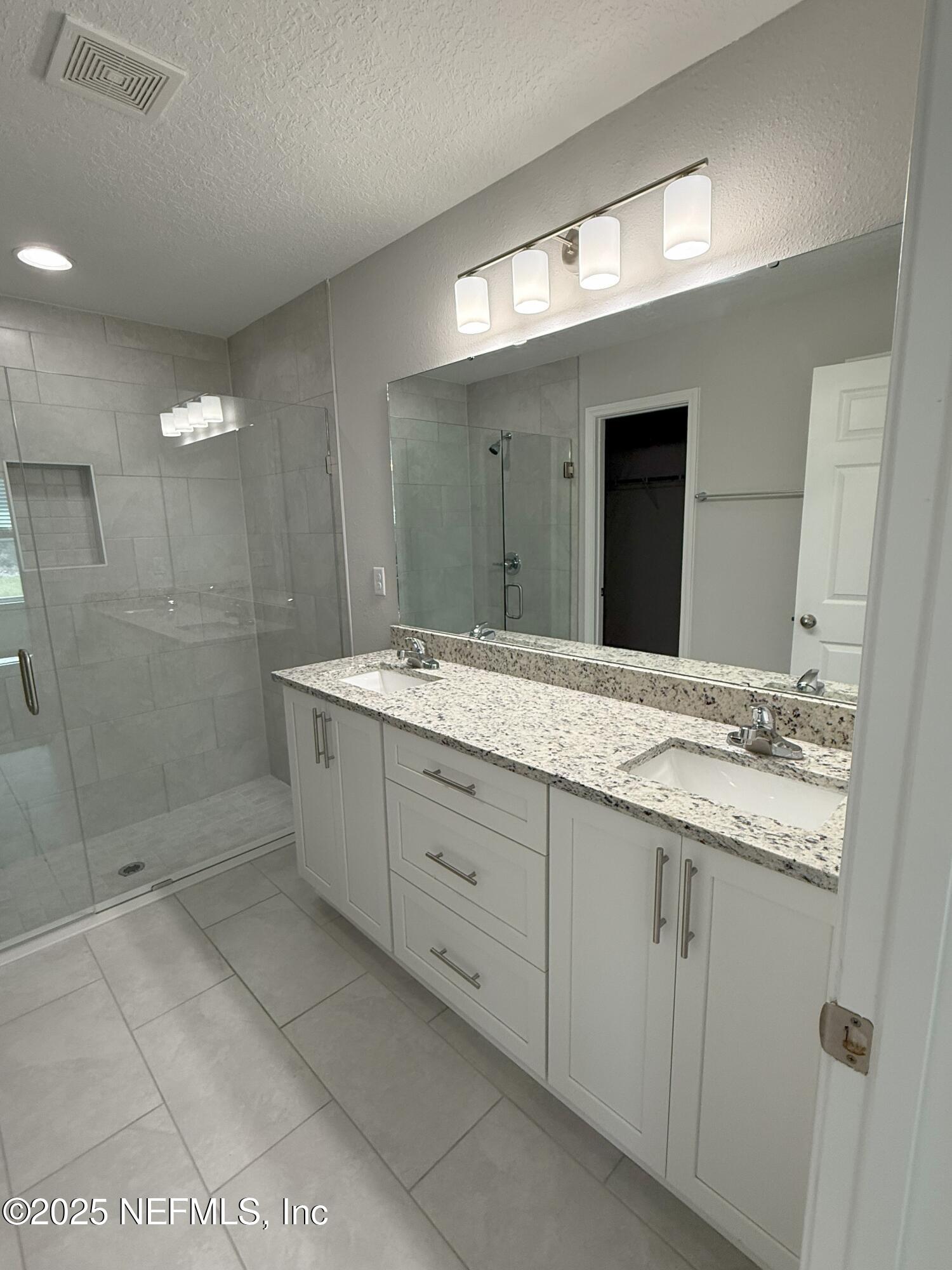 10286 Cisco Drive Jacksonville, FL 32219 - Photo 4 of 45 a bathroom with a shower sink and mirror
