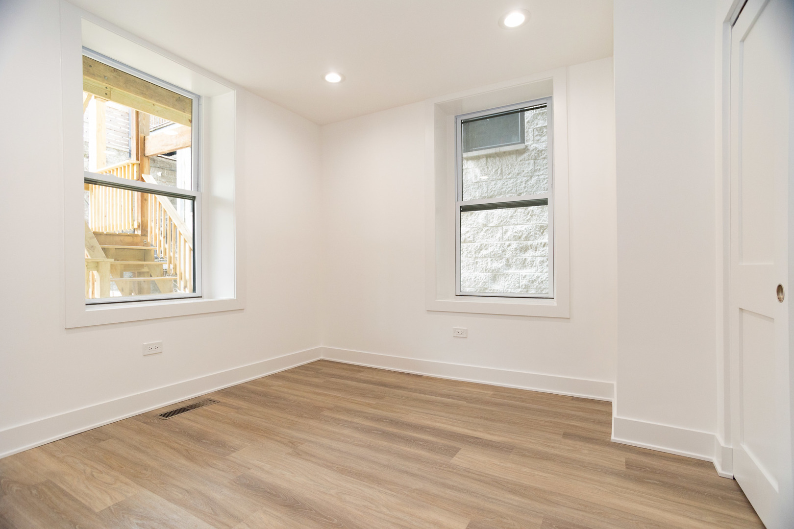 1723 West Pierce Avenue, Unit 1 Chicago, IL 60622 - Photo 11 of 24 an empty room with wooden floor and windows