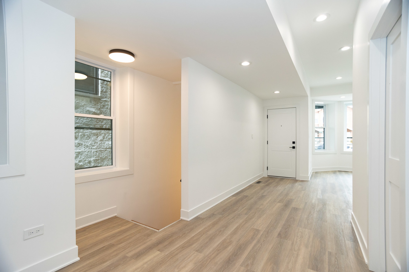 1723 West Pierce Avenue, Unit 1 Chicago, IL 60622 - Photo 14 of 24 an empty room with wooden floor and windows