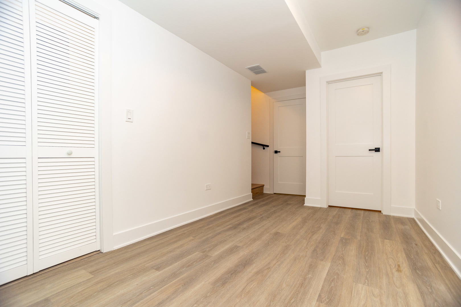 1723 West Pierce Avenue, Unit 1 Chicago, IL 60622 - Photo 17 of 24 an empty room with wooden floor and white walls