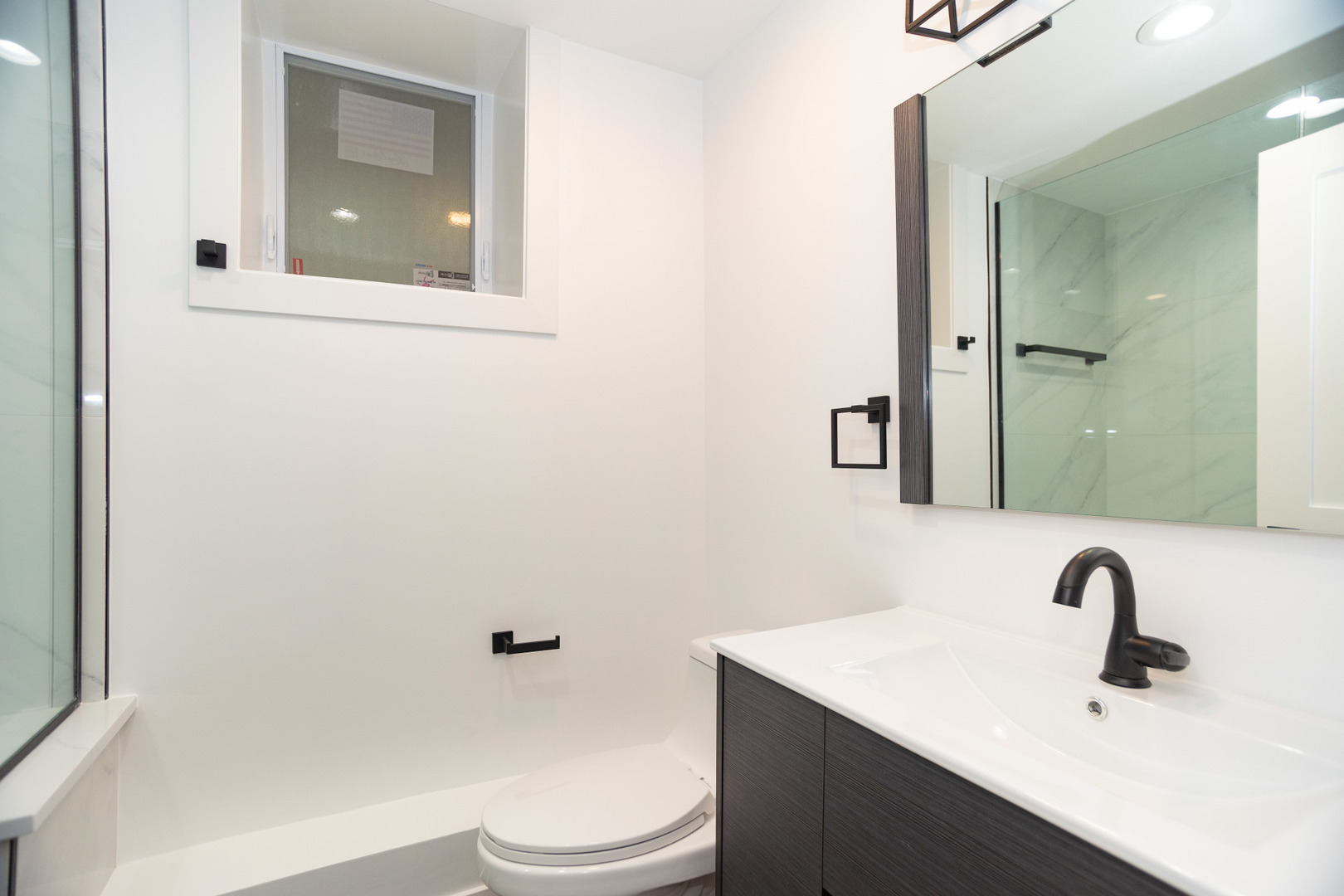 1723 West Pierce Avenue, Unit 1 Chicago, IL 60622 - Photo 21 of 24 a bathroom with a sink a toilet and shower
