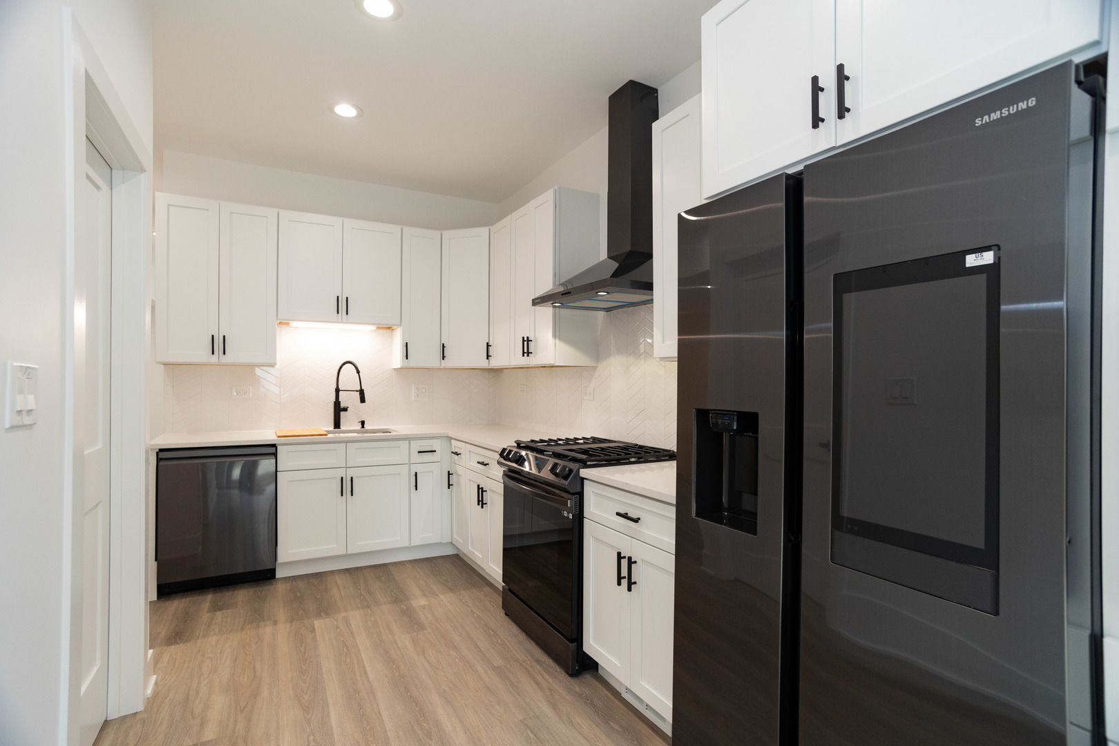 1723 West Pierce Avenue, Unit 1 Chicago, IL 60622 - Photo 8 of 24 a kitchen with stainless steel appliances granite countertop white cabinets a sink dishwasher a refrigerator and a stove