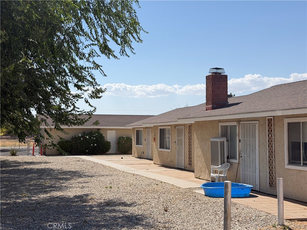 13269 Mohawk Road Apple Valley, CA 92308 - Photo 8 of 8 a front view of a house with a yard and garage