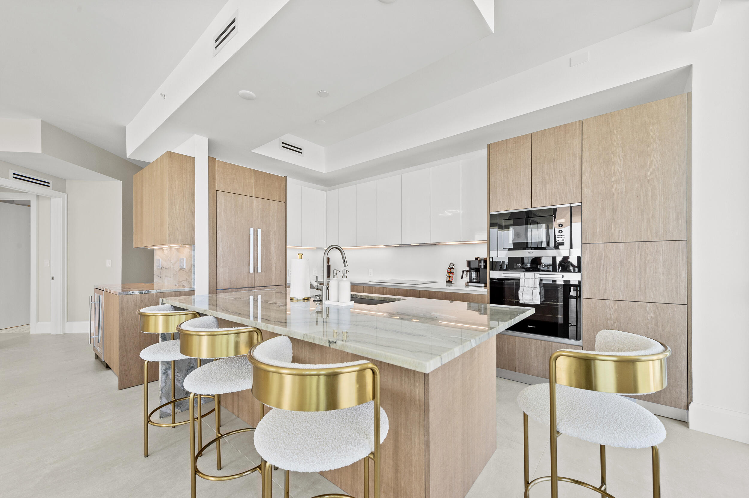 3100 North Ocean Drive, Unit 1103H Riviera Beach, FL 33404 - Photo 12 of 50 a kitchen with stainless steel appliances kitchen island granite countertop a table chairs and a refrigerator