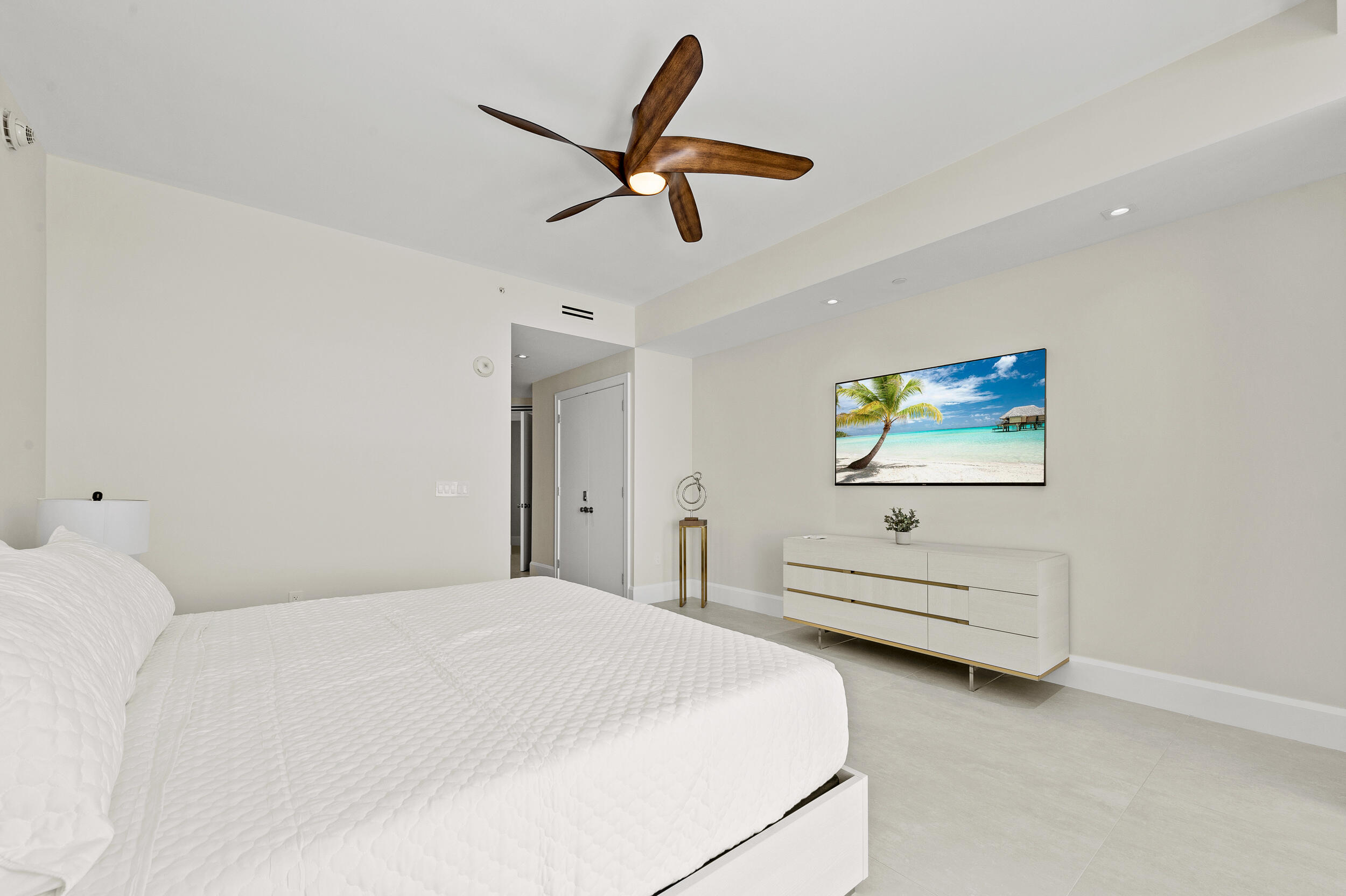3100 North Ocean Drive, Unit 1103H Riviera Beach, FL 33404 - Photo 20 of 50 a bedroom with a bed and a chandelier