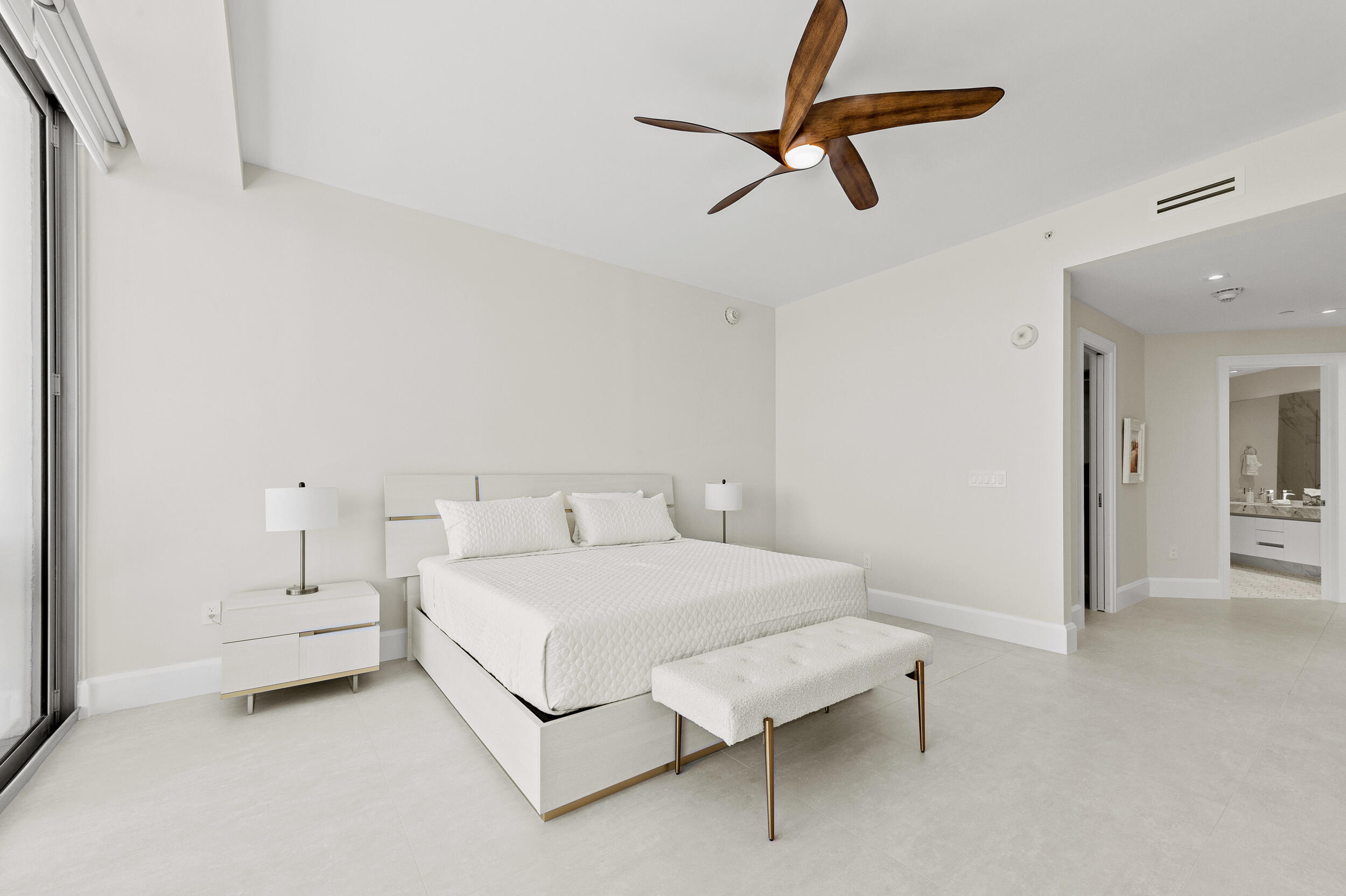 3100 North Ocean Drive, Unit 1103H Riviera Beach, FL 33404 - Photo 22 of 50 a bedroom with a bed and a chandelier