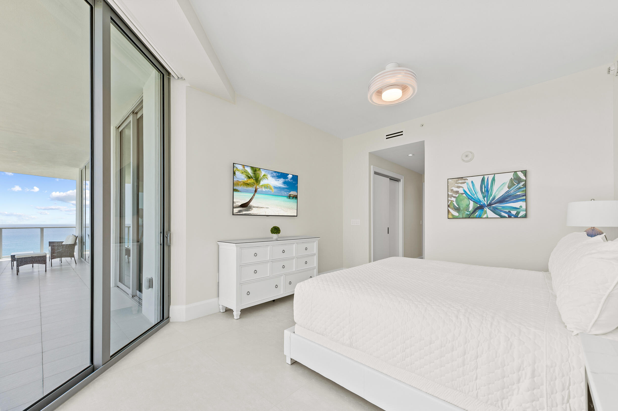 3100 North Ocean Drive, Unit 1103H Riviera Beach, FL 33404 - Photo 26 of 50 a bedroom with a bed and a dresser