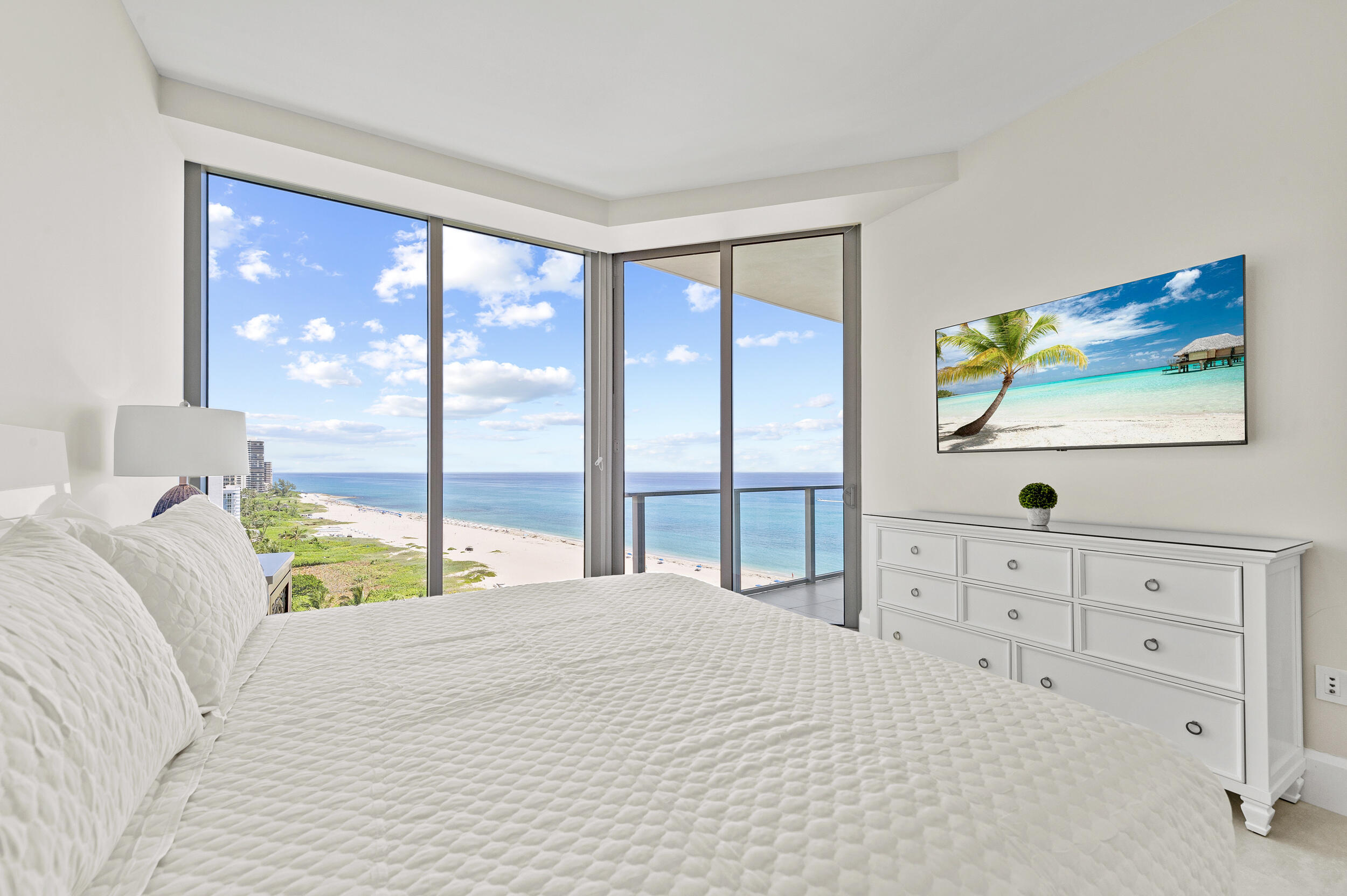 3100 North Ocean Drive, Unit 1103H Riviera Beach, FL 33404 - Photo 27 of 50 a bedroom with a large bed and a window