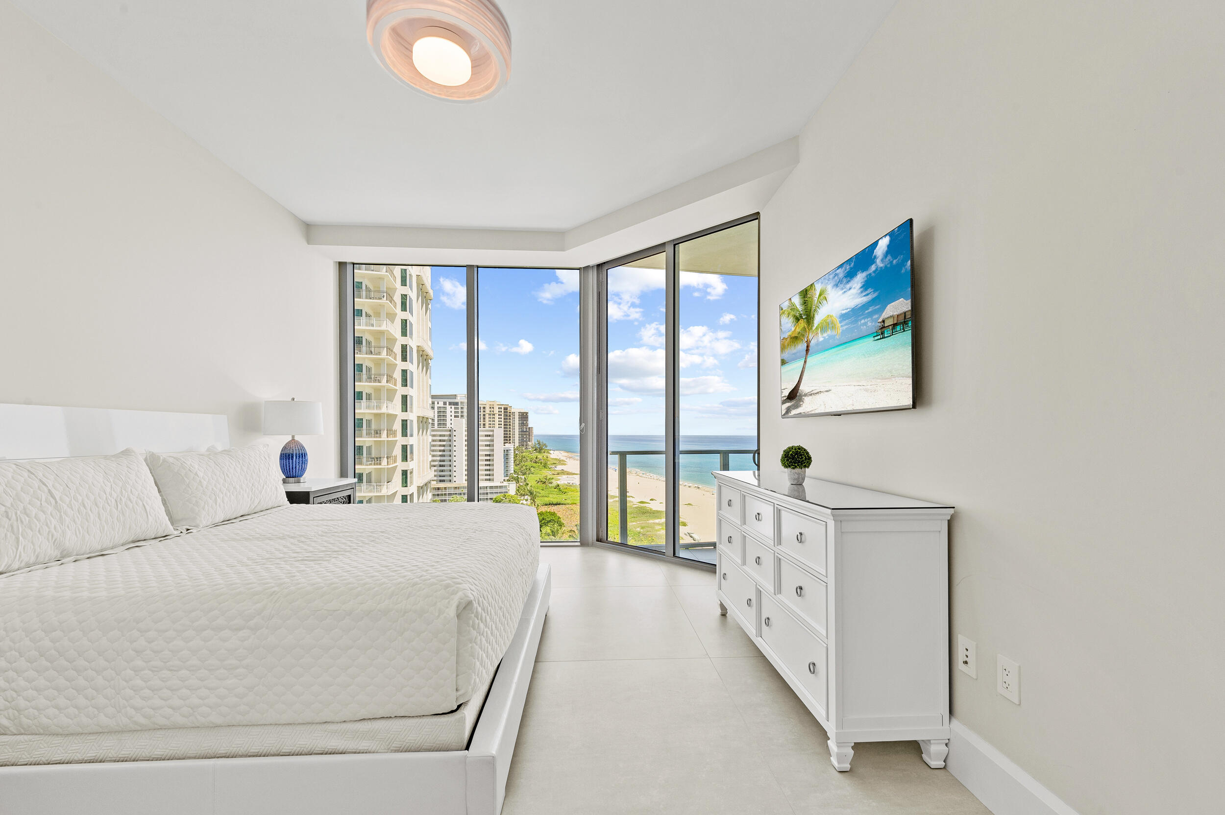 3100 North Ocean Drive, Unit 1103H Riviera Beach, FL 33404 - Photo 28 of 50 a spacious bedroom with a large bed and a large window