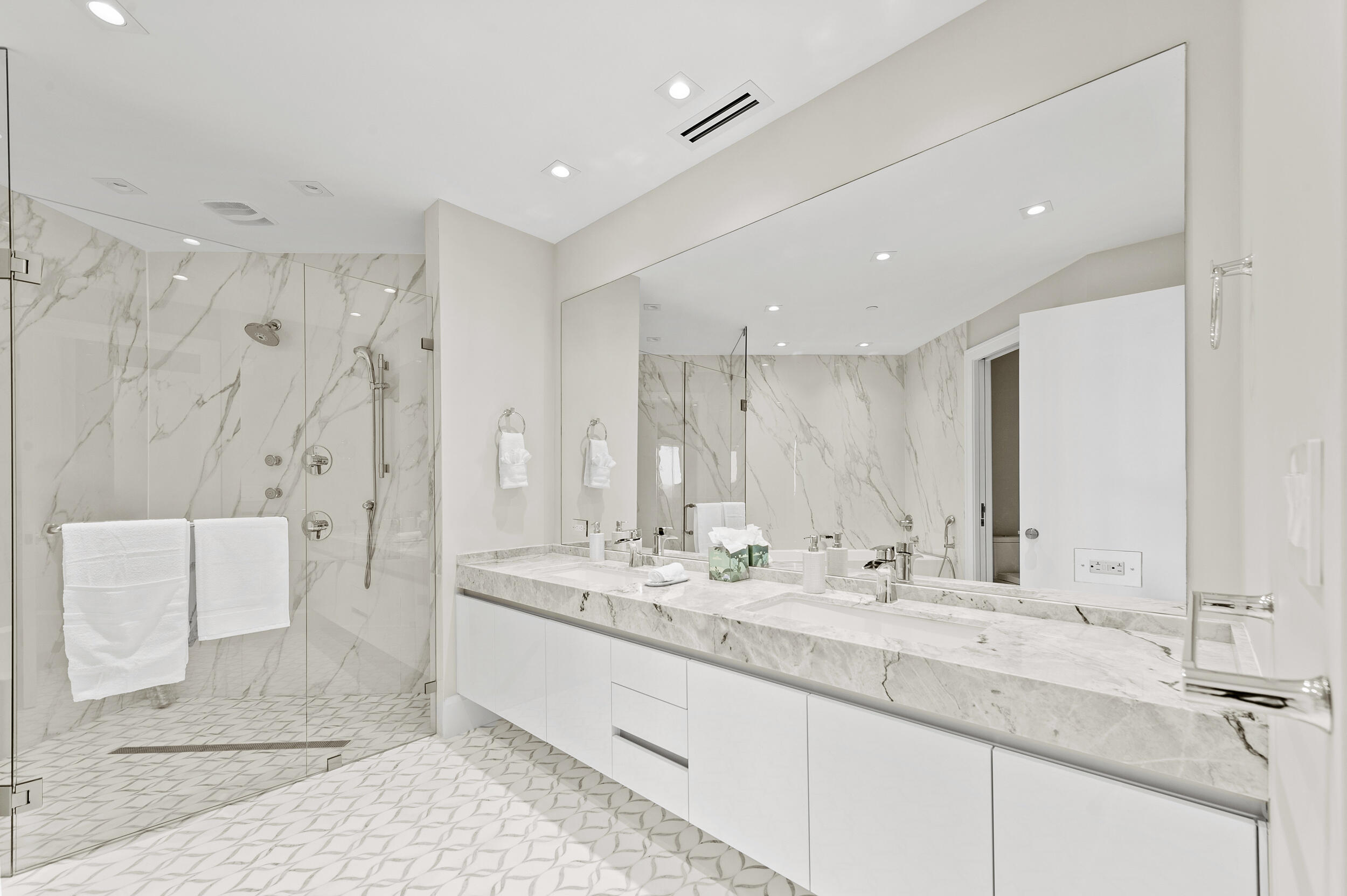 3100 North Ocean Drive, Unit 1103H Riviera Beach, FL 33404 - Photo 30 of 50 a bathroom with double vanity sinks and a mirror