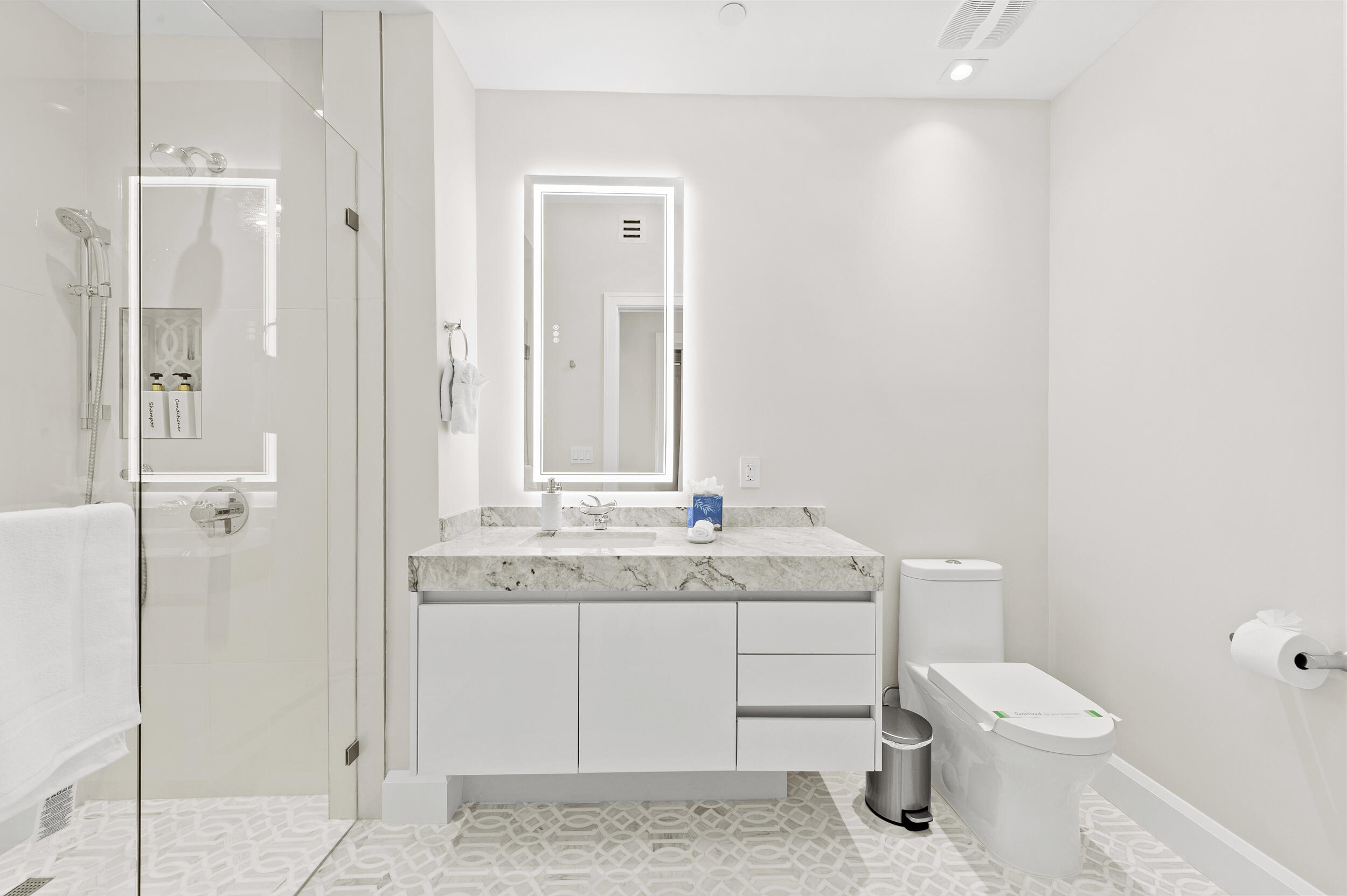 3100 North Ocean Drive, Unit 1103H Riviera Beach, FL 33404 - Photo 33 of 50 a bathroom with a granite countertop toilet a sink and a mirror