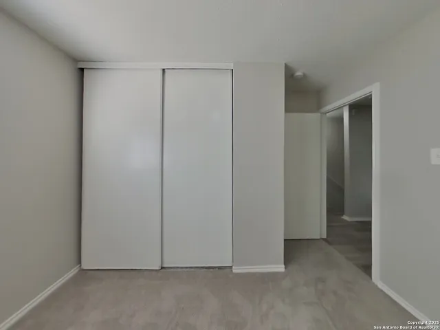 an empty room with closet area