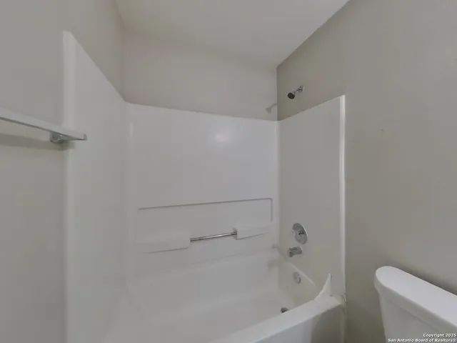 a bathroom with a bathtub and toilet
