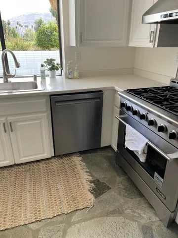 a view of a dining room with furniture wooden floor and a potted plant