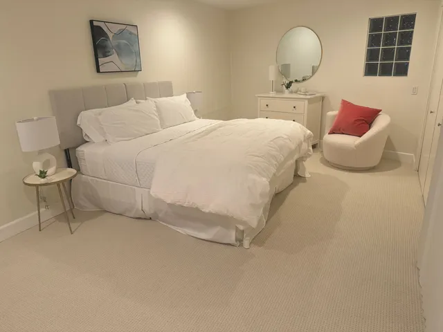a bedroom with a bed and cabinets