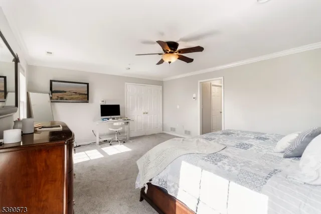 a bedroom with a bed and a desk