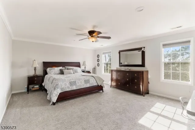 a spacious bedroom with a bed and a tv